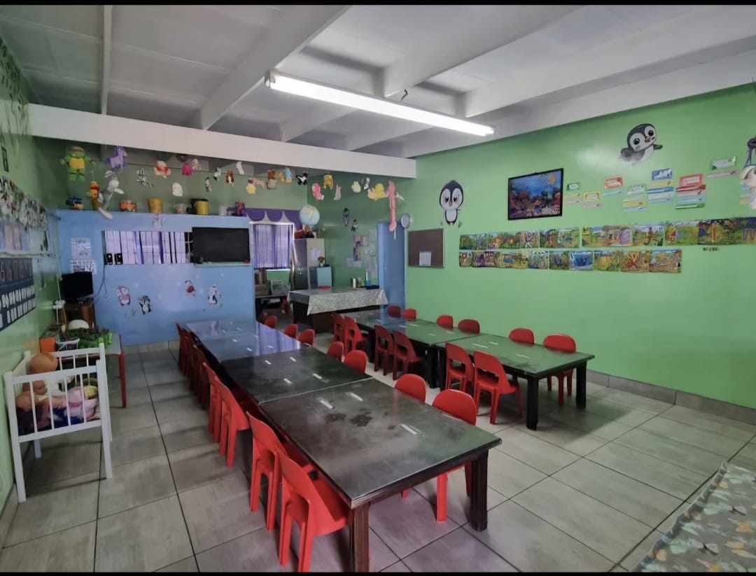 A spacious green classroom set up for children